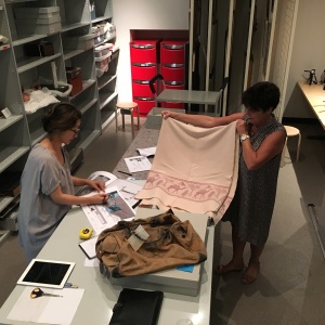 CONSERVATOR AND DESIGNER WORKING OUT BEST WAY TO DISPLAY OBJECTS