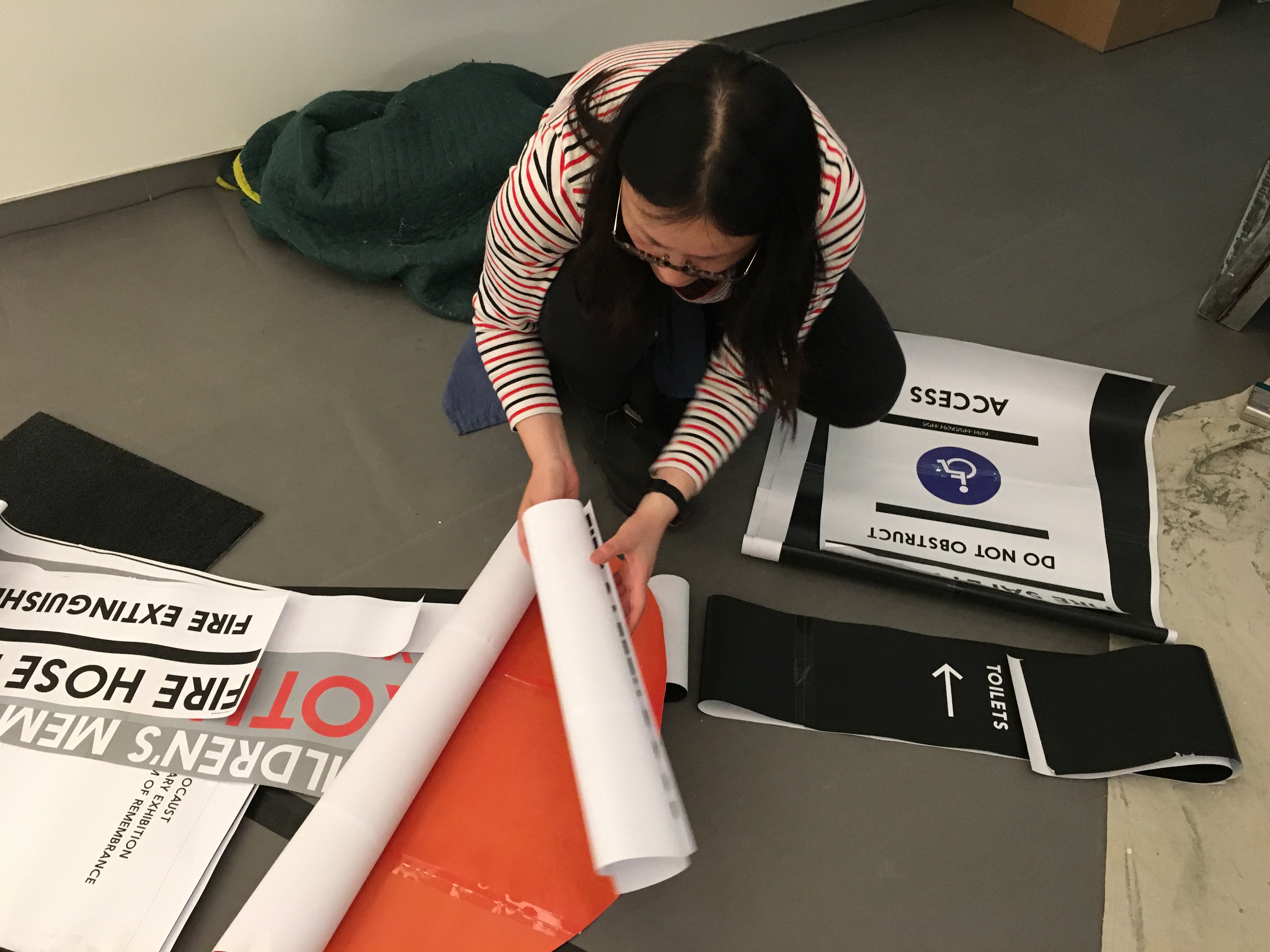 Designer Haimeng testing fonts and sizes for Museum signage. 