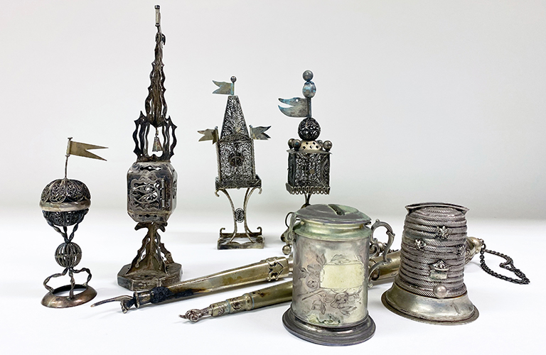 A collection of silver Judaica objects on a white background