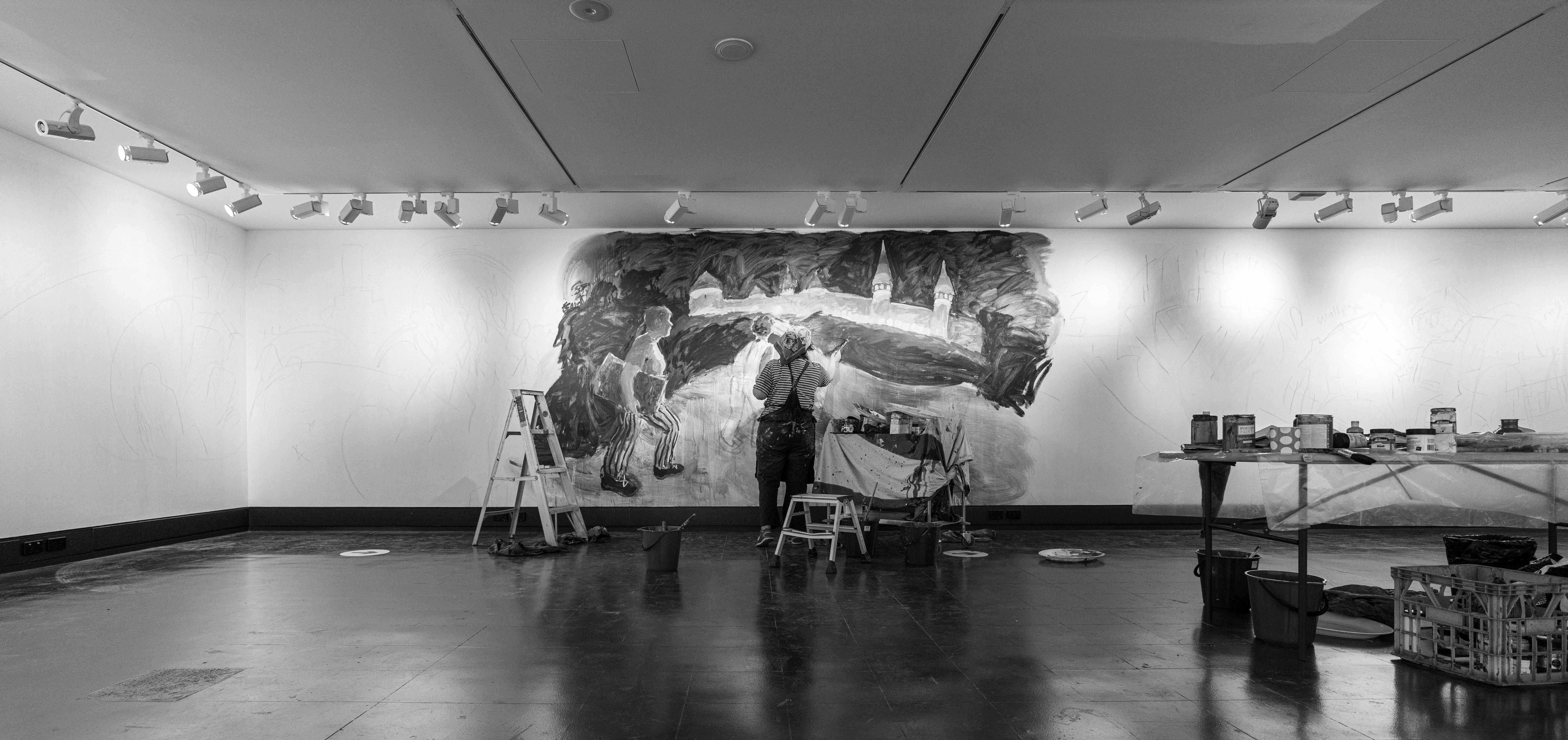Artist, Wendy Sharpe, painting a large mural in Sydney Jewish Museum